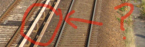 A third rail is normally a structure on stands right next to the rails.
